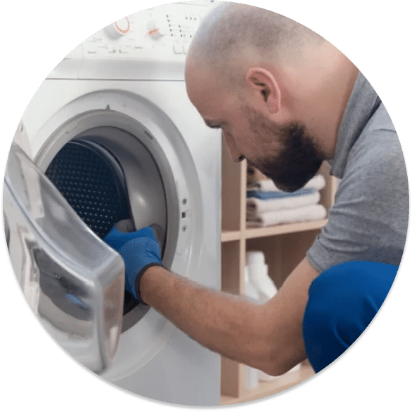 A contractor fixing a laundry machine